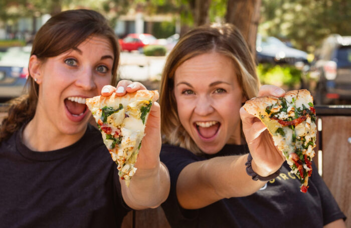 two women enjoyinh pizza at Walter's303